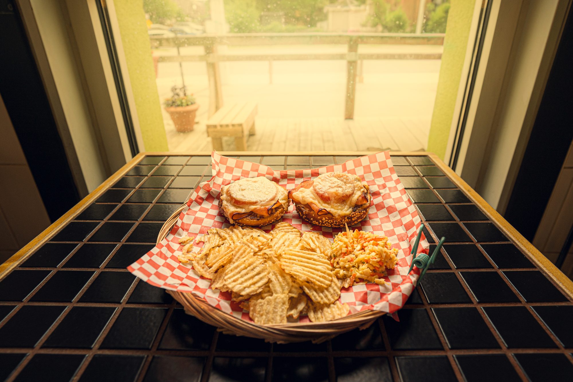 A basket of melts and chips on the counter by the window