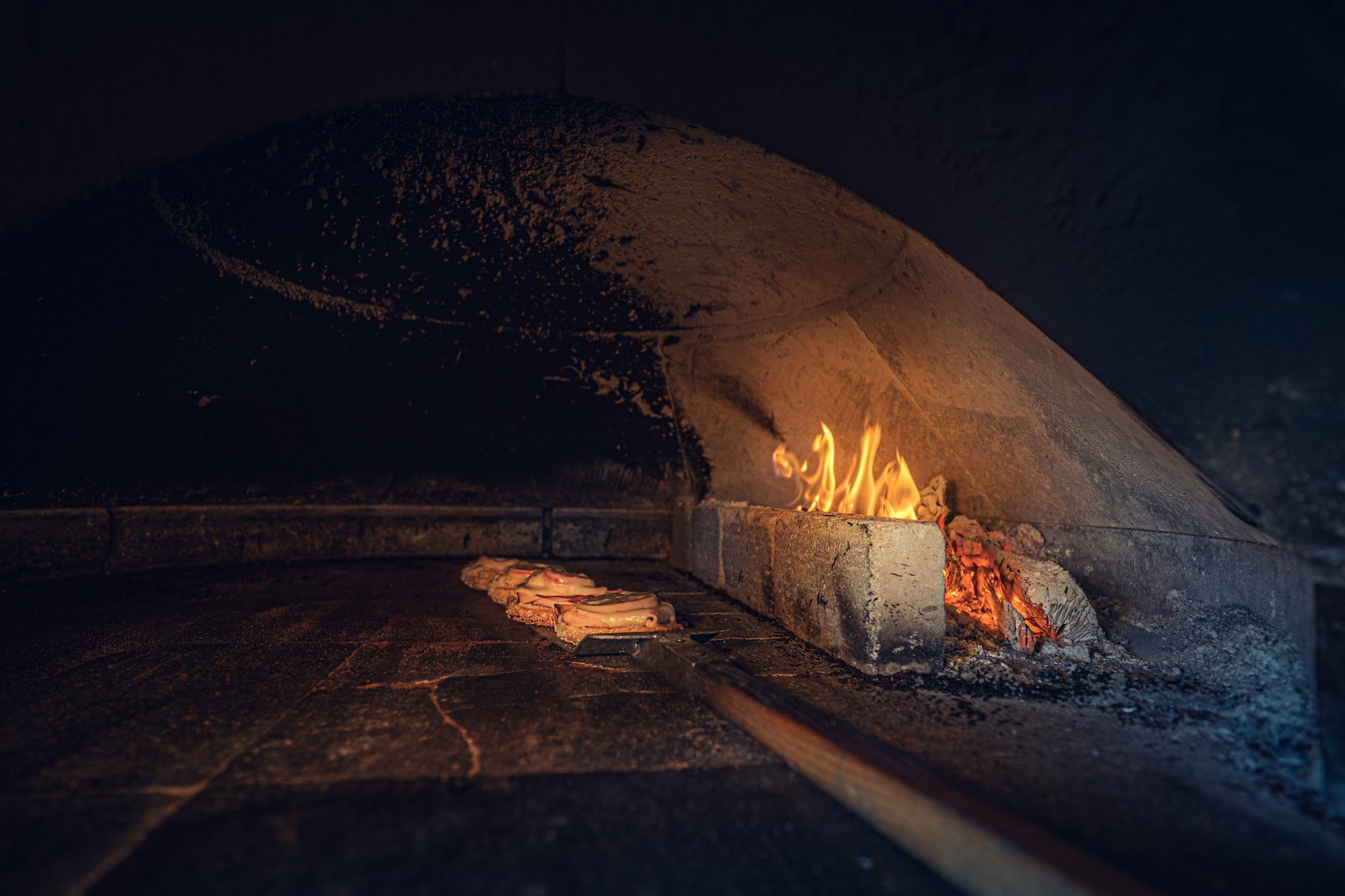 Flames burning at the back of the wood-fired oven
