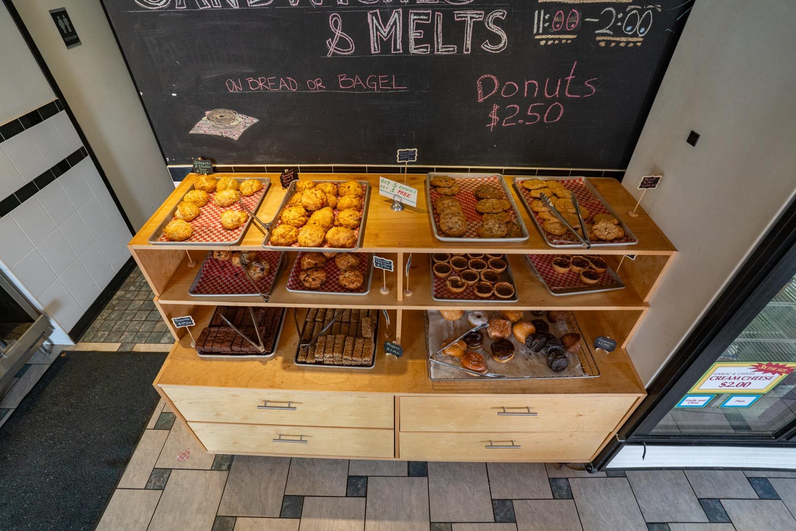 Wooden shelves stacked with the morning's pastries below the melts board